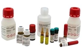 A collection of various chemical bottles and containers with different sizes, shapes, and colors. Some bottles have red caps and labels with hazard symbols indicating flammable and corrosive substances. There are also small vials with yellow liquid, alongside tubes with white caps.