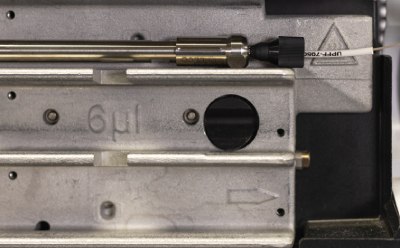 Zoomed-in picture of the column connected properly to the inlet tubing. Zoomed-in picture of the Supelco® analytical HPLC column connected properly to the inlet tubing of Agilent® 1290 U/HPLC instrument.