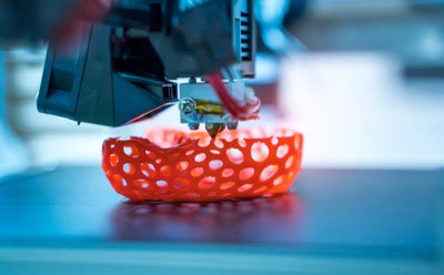 Stereolithography 3D printer showing 3D object emerging from vat of resin