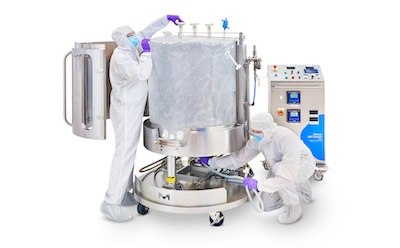 Mobius<sup>®</sup> ADC Reactor Two operators, fully gowned, installing the single-use Ultimus® Bag in the Mobius® ADC reactor