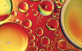Extreme close-up of detergent bubbles in different sizes