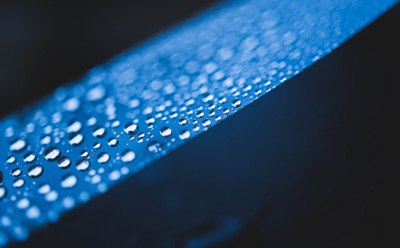 Superhydrophobic polymer coating surface Water droplets on blue superhydrophobic polymer