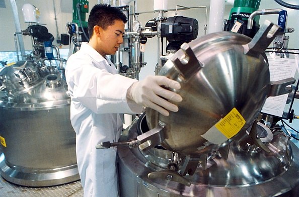 Upstream Process Chemicals Worker loading upstream chemicals for bioprocessing