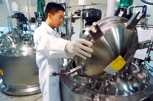 Worker loading upstream chemicals for bioprocessing