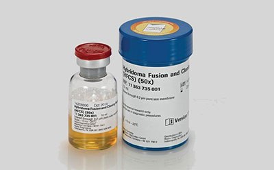 The image features two containers, a small glass vial with a red cap, containing a yellow liquid. The label includes the words “HYBRIDOMA,” “SERUM-FREE,” and some numerical codes. Second is a larger blue plastic container labeled “Hybridoma Fusion and Cloning Supplement (HFCS) (50x)” with additional text including a numerical code “B11 343 735 001” and the logo of GE Healthcare Life Sciences.