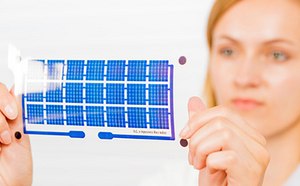 Printed electronic device held by a researcher.