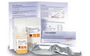 A collection of items related to analytical chemistry standards. It includes a bottle with a yellow label and several documents. One document is an accreditation document. Another paper shows printed graphs and text. The background is white and nondescript.