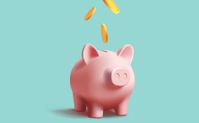 A close-up image of a pink piggy bank with coins dropping into its slot.