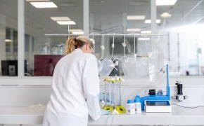 Operator in a lab working with a Cell Retention device.