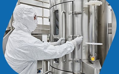 Manufacturing operator in PPE operates a 1,000L single-use bioreactor during AAV production Manufacturing operator in PPE operates a 1,000L single-use bioreactor during AAV production