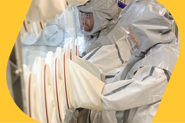 Safe Handling of HPAPIs Safe handling of highly potent APIs in isolator by two operators in protection suits