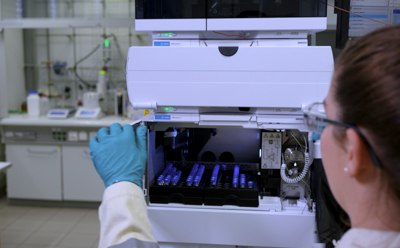 Lab scientist is loading analytical samples into a High-Performance Liquid Chromatography (HPLC) machine for monitoring the progress of chemical syntheses and ensuring the quality of the produced materials. Lab scientist is loading analytical samples into a High-Performance Liquid Chromatography (HPLC) machine for monitoring the progress of chemical syntheses and ensuring the quality of the produced materials.