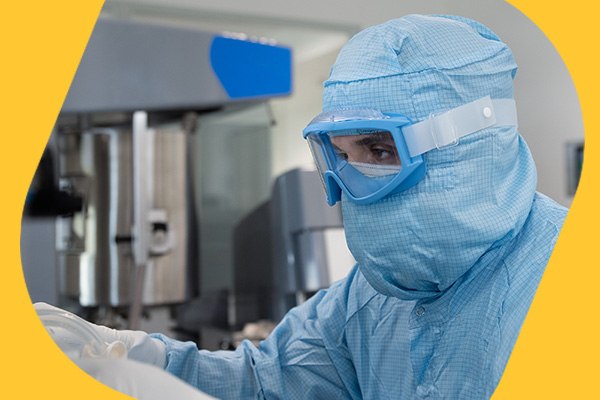 mRNA Drug Substance Manufacturing Services Operator pushing mRNA drug substance bag into freezing trays