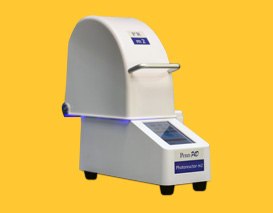 A laboratory photoreactor instrument with a curved top and a digital display, designed for sample processing, set against a yellow background.