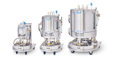 Three Mobius Single-Use Bioreactors (10 L, 100 L, 500 L) aligned next to each other. Each bioreactor consists of a cylindrical vessel with multiple ports and tubes attached, mounted on a wheeled support structure for mobility. Three Mobius Single-Use Bioreactors (10 L, 100 L, 500 L) aligned next to each other. Each bioreactor consists of a cylindrical vessel with multiple ports and tubes attached, mounted on a wheeled support structure for mobility.