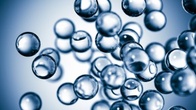 A close-up view of transparent bubbles floating against a soft blue background, creating a sense of depth and movement A close-up view of transparent bubbles floating against a soft blue background, creating a sense of depth and movement